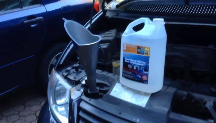 How do I flush the coolant system in a Dodge Caravan
